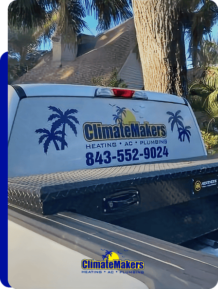 A climatemakers truck with a "ClimateMakers Heating AC Plumbing" decal, phone number 843-552-9024, and palm tree graphics is parked near trees and a building.