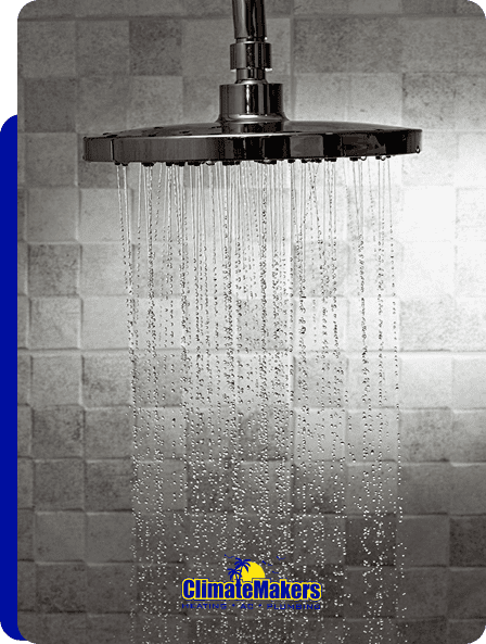 A modern chrome showerhead sprays water against a tiled wall, with the climatemakers logo at the bottom.
