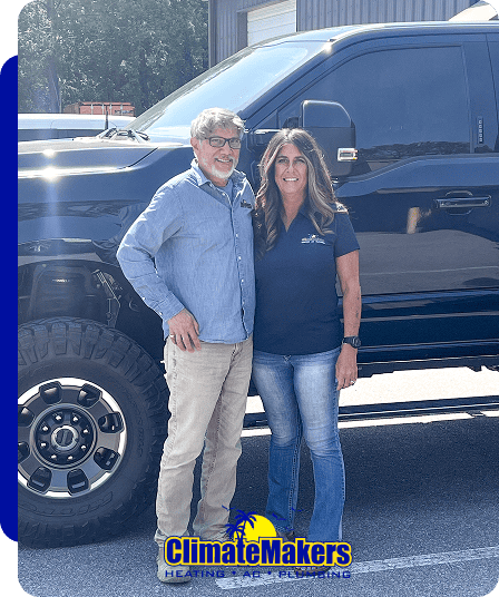 Two people stand and smile in front of a large black truck in a parking lot. The ClimateMakers Heating & Air Conditioning logo appears at the bottom of the image.